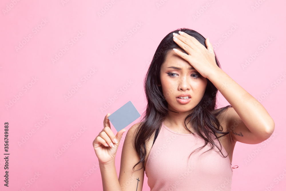 Young Asian woman headache with a blank card. Young Asian woman headache with a blank card.