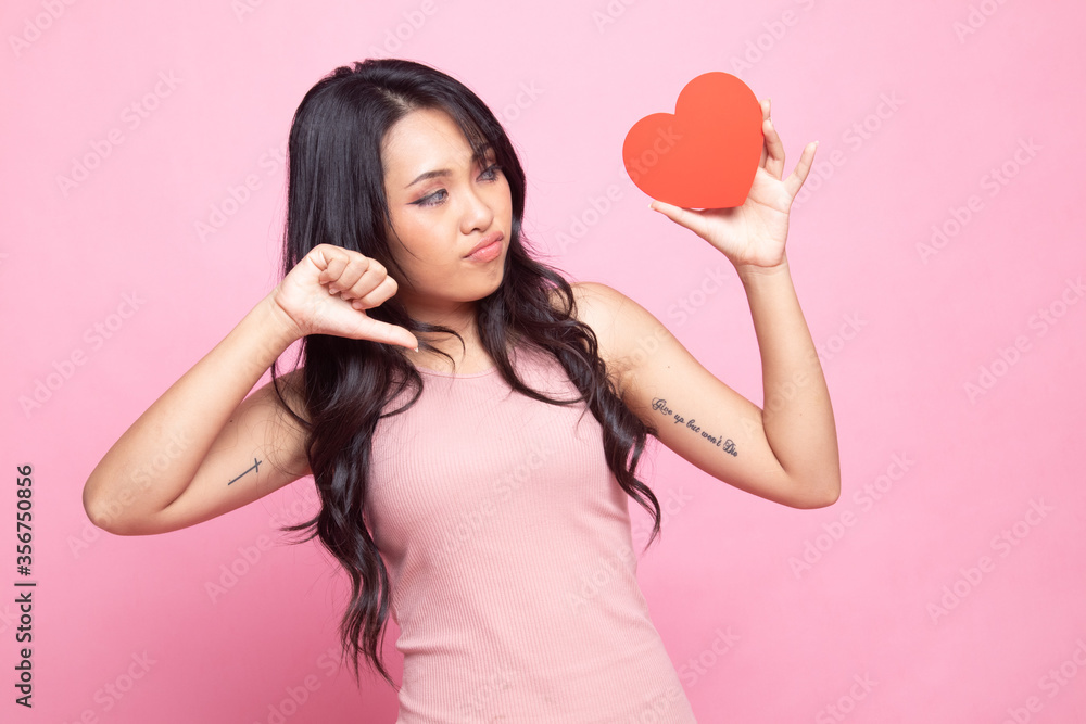 Asian woman thumbs down with red heart. Asian woman thumbs down with red heart.