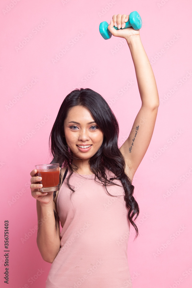 Healthy Asian woman with dumbbell and tomato juice. Healthy Asian woman with dumbbell and tomato juice.