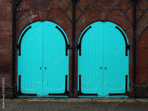 Two turquoise doors in old building