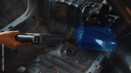 Close Up on a Handheld 3D Scanner Scanning the Interior of a Mazda RX7. photo