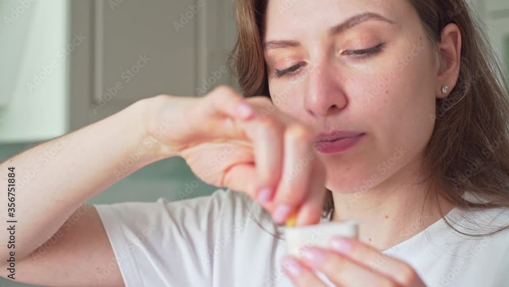 Woman dips French fries into sauce. Unhealthy fast food Woman dips French fries into sauce. Unhealthy fast food