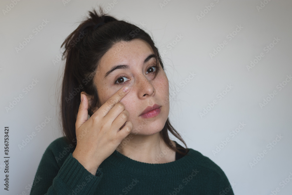 Woman touching eye area