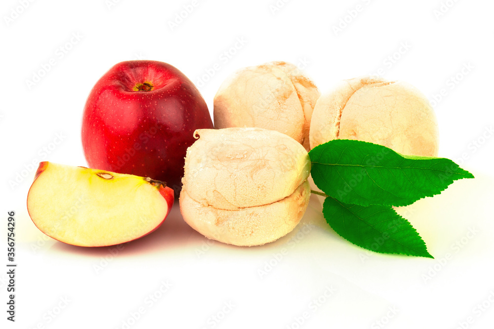 Red apple, marshmallows, slices and green leaves