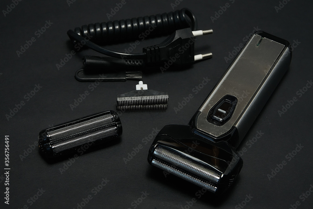 Rechargeable electric shaver for men, black background. Rechargeable electric shaver for men, black background.