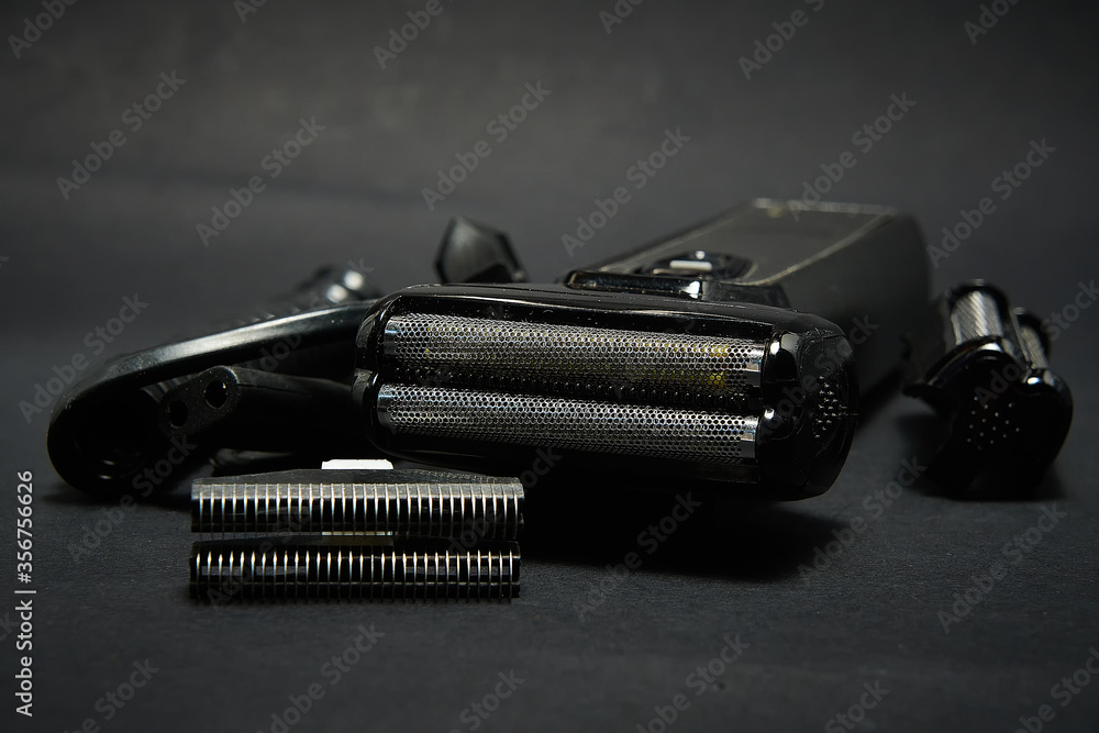 Rechargeable electric shaver for men, black background. Rechargeable electric shaver for men, black background.