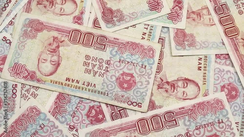 A close up video of colorful five hundred dong bank notes rotating in a circle