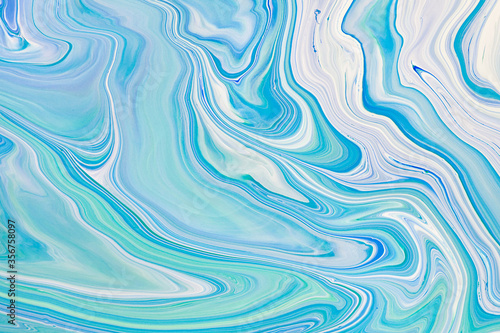 Fluid art texture. Abstract background with swirling paint effect. Liquid acrylic picture with flows and splashes. Mixed paints for posters or wallpapers. Blue, white and mint overflowing colors
