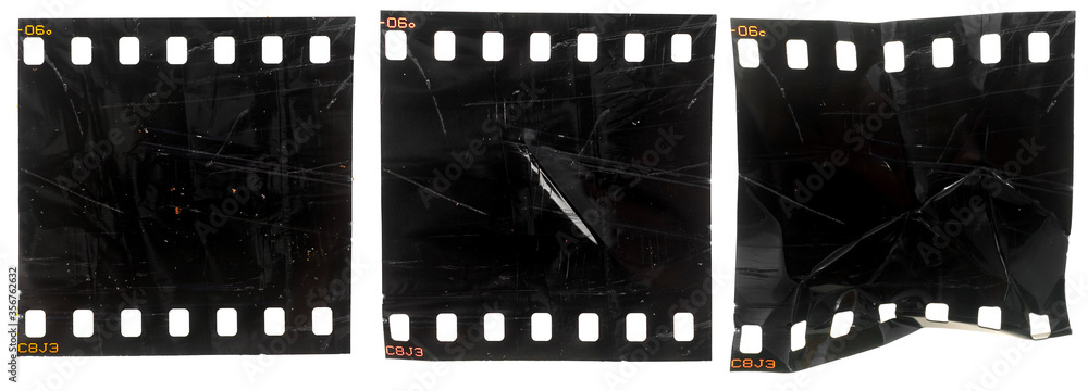 set of three black and exposed 35mm filmstrips or snips with scratches and marks on white background, rumpled film material
