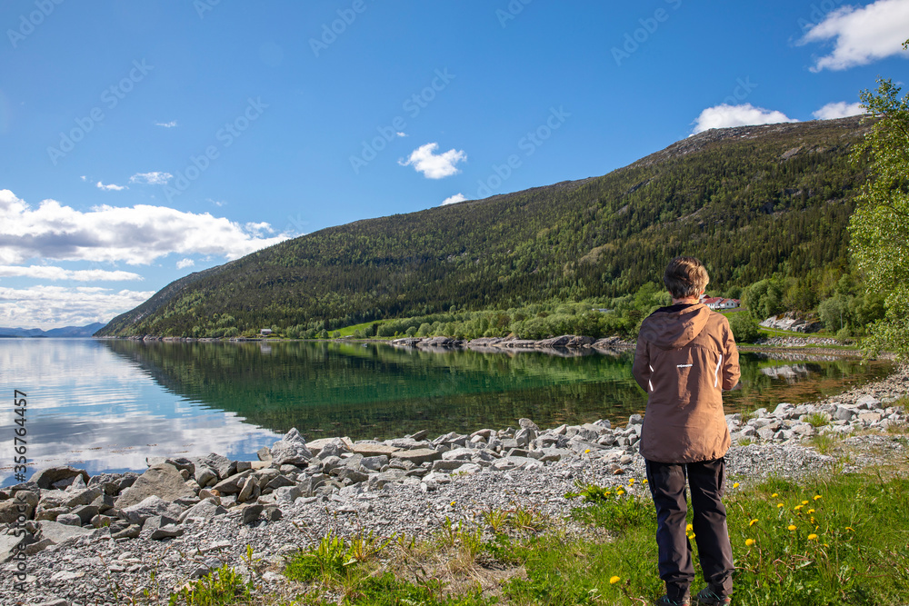 Happy lady on a hike by the seaside, Nordland county