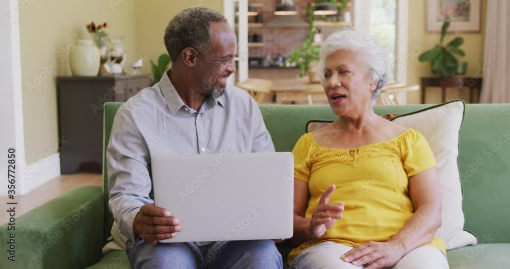 Senior African American husband and mixed race wife spending time and working at home Senior African American husband and mixed race wife spending time and working at home