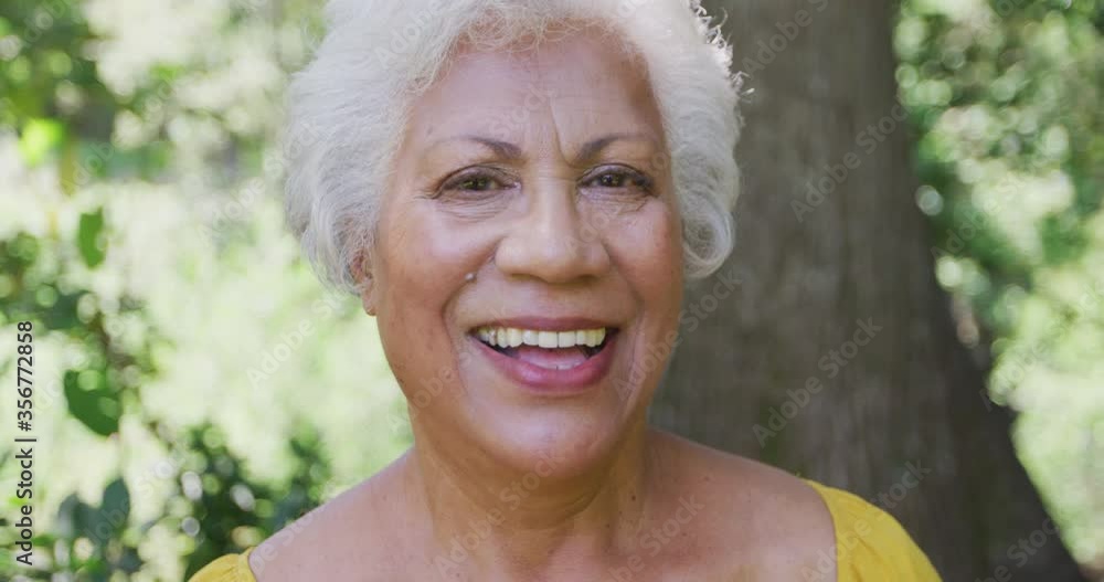 Senior mixed-race woman smiling and looking at the camera