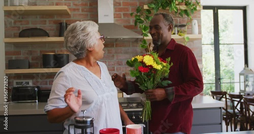 Wallpaper Mural Senior African American husband offering flowers to his mixed-race wife, hugging and smiling Torontodigital.ca