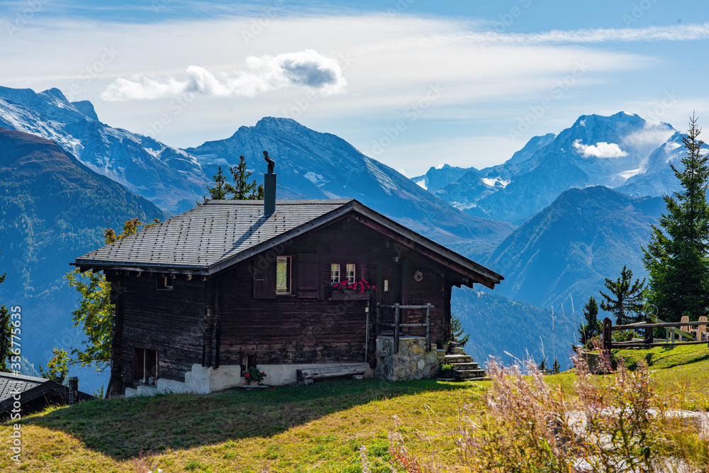 Idyllic landscape in Swiss Alps with chalet and mountains on background, Bettmeralp, Canton of Valais, Switzerland