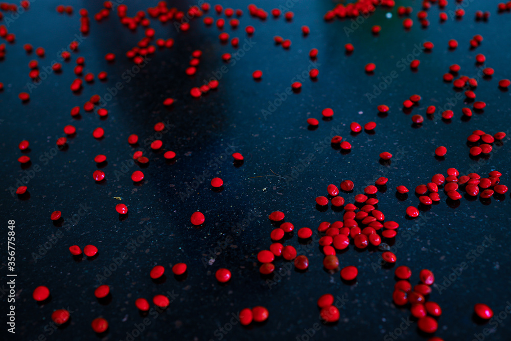 Red sandalwood (Adenanthera pavonina) seeds isolated on a black background. Manchadi, Manjadi, Manjetti, Peacock flower fence, Acacia Coral, Anikundumani, Bandi guruvenda, Barbados pride, Barricarri. Red sandalwood (Adenanthera pavonina) seeds isolated on a black background. Manchadi, Manjadi, Manjetti, Peacock flower fence, Acacia Coral, Anikundumani, Bandi guruvenda, Barbados pride, Barricarri.
