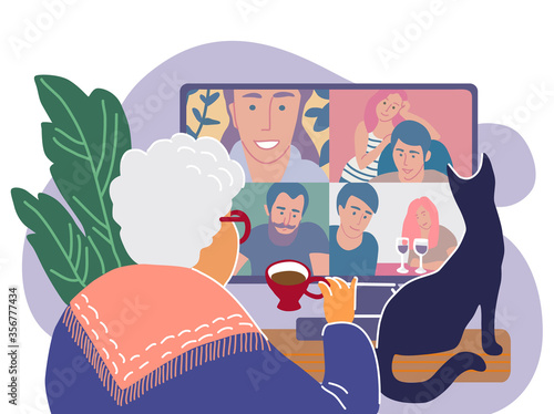 Old woman chatting while sitting in front of the screen with a cup of tea and cat.
