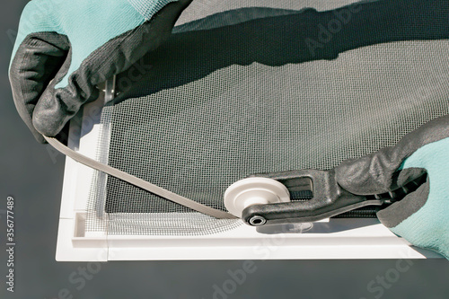 A worker makes a mosquito net