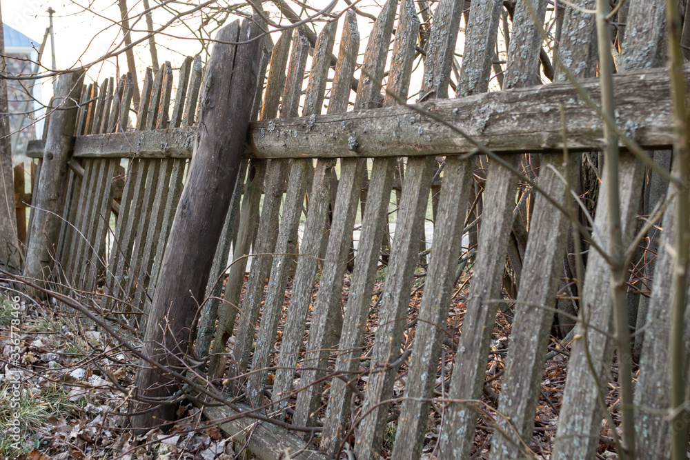 An old, twisted wooden fence in the village.