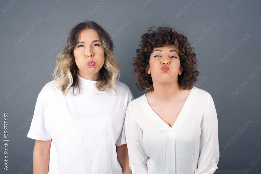 Beautiful young woman puffing cheeks with funny face. Mouth inflated with air, crazy expression. Beautiful young woman puffing cheeks with funny face. Mouth inflated with air, crazy expression.