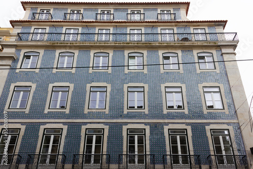Traditional Portuguese building with blue tiles facade in Lisbon on cloudy day