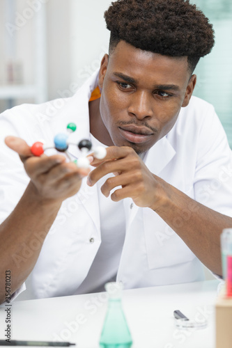male scientist with molecules model photo