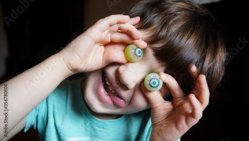 young boy looking through a magnifying glass