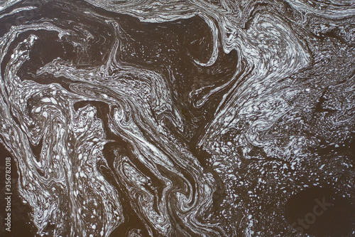 Aerial view of changing patterns of foam on the surface of the water © alexkazachok