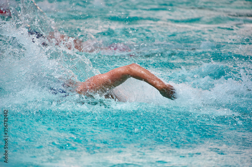 Athlete training swimming in wave pool at gym blue water splashing competition © goldenbergk
