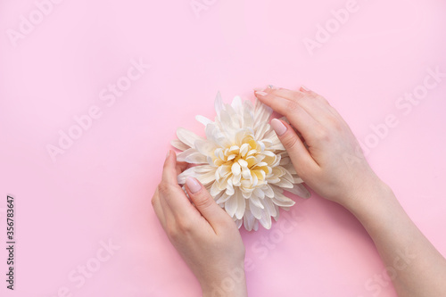 Woman moisturizing her hand with cosmetic cream  concept for feminine blog  social media  beauty concept