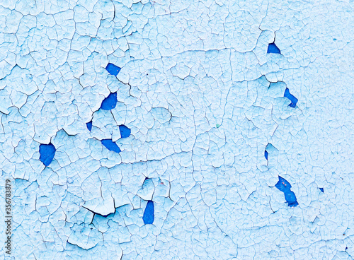 Old peeling blue painted wall. Close up