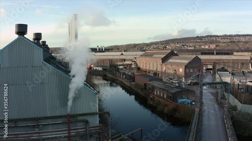 Aerial shot of steam from a pipe at from a steel forge warehouse in Sheffield during a cold Winter morning