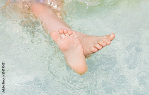 Children s feet close up in the water