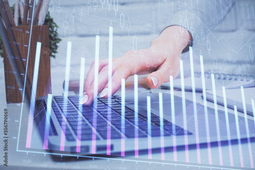 Multi exposure of woman hands typing on computer and forex chart hologram drawing. Stock market analysis concept.