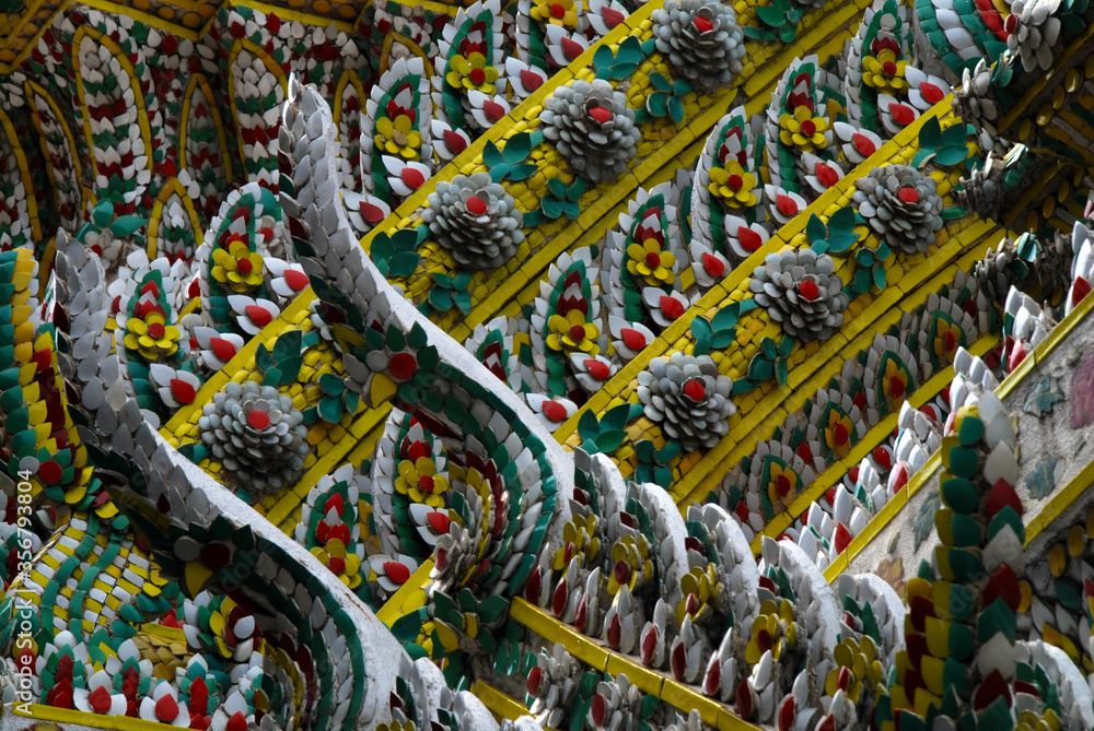 close-up on ornaments in gold and gemstones at facade of temple in Bangkok close-up on ornaments in gold and gemstones at facade of temple in Bangkok