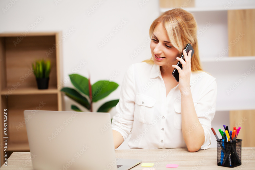 Young female businesswoman working in her office on laptop Young female businesswoman working in her office on laptop