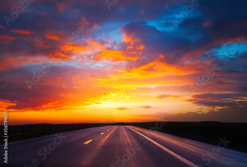 Straight asphalt highway at sunset © lumikk555