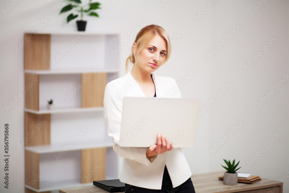 Young female businesswoman working in her office on laptop Young female businesswoman working in her office on laptop