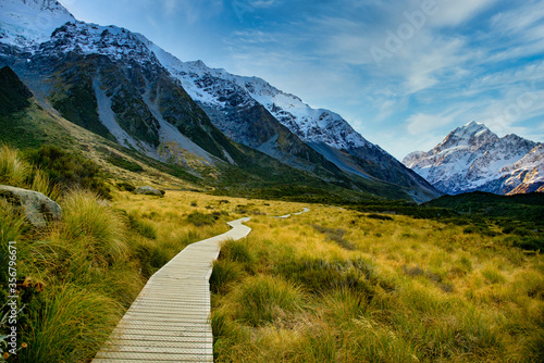 The wooden boardwalk providing the pathway through Hooker Valley Track in Aoraki Mt Cook National park towards NZ highest mountain in the Southern Alps