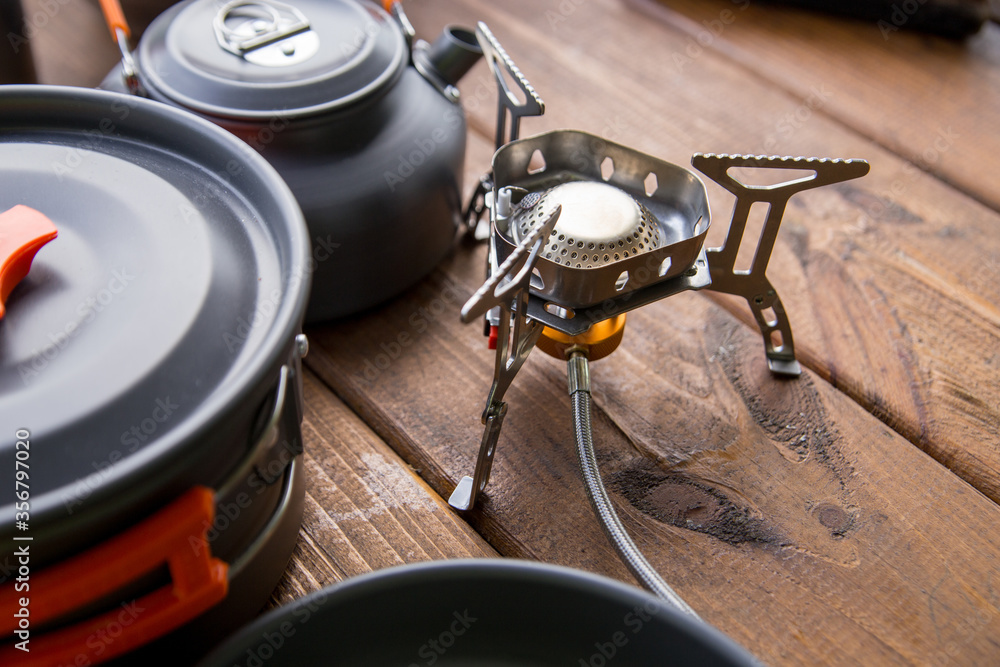 tourist gas burner and utensils standing on the table tourist gas burner and utensils standing on the table