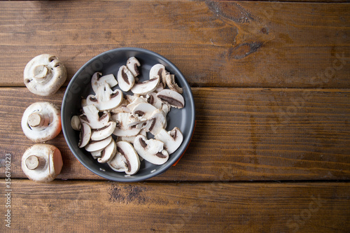 sliced mushrooms lie in a pan