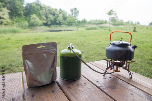 a package of freeze-dried food and a gas burner for cooking on a picnic or at a campsite
