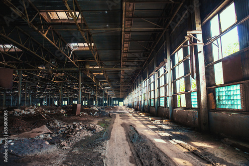 Dirty abandoned ruined industrial building inside, toned