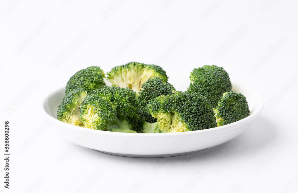 fresh broccoli in a dish on white background fresh broccoli in a dish on white background