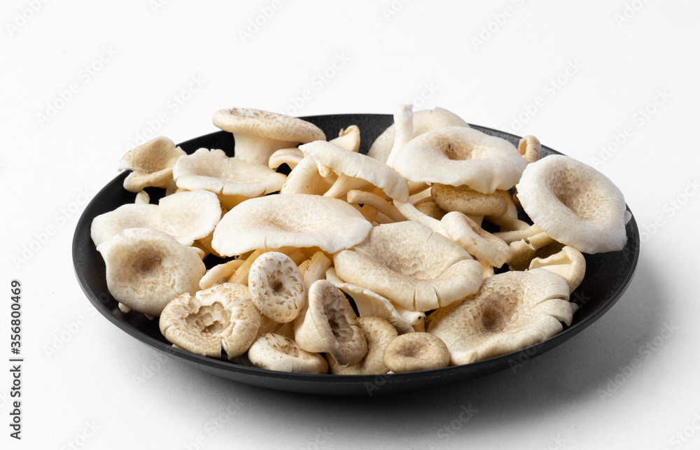 fresh whole mushrooms in a dish on white background fresh whole mushrooms in a dish on white background