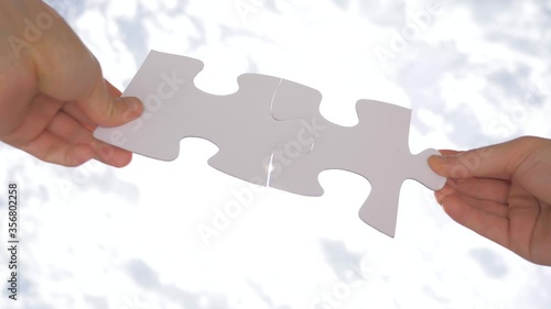 Psychology of relationships. Logic, interconnection, teamwork. Puzzle pieces connected. Hand matching jigsaw halves, love concept. Positive relationships. Perfect combination. Sutable photo