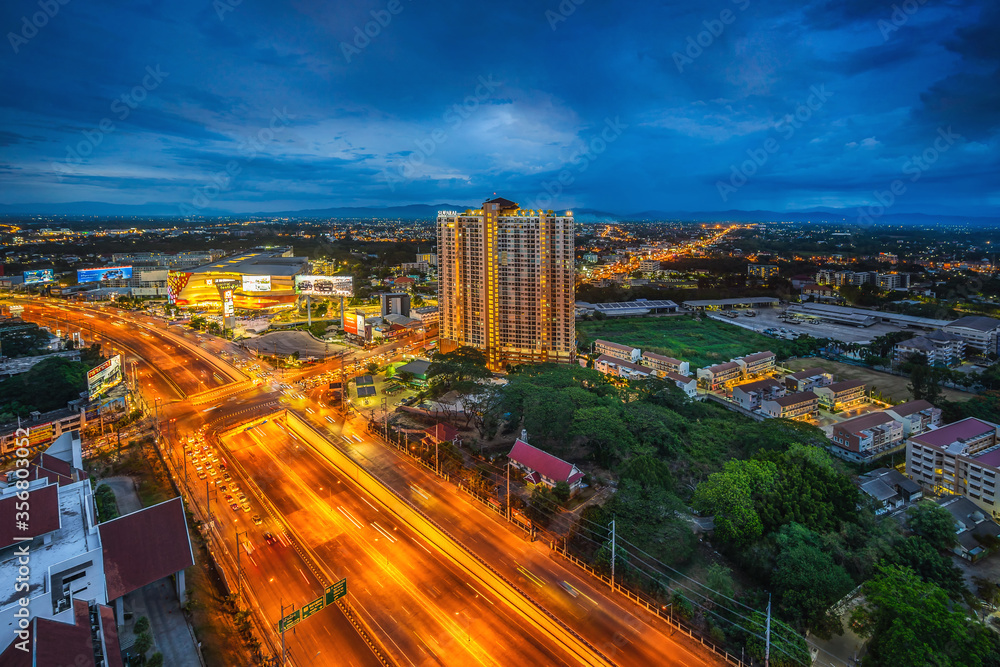 Fototapeta premium CHIANG MAI, THAILAND - June 6,2020: Time lapse Aerial view Chiang Mai City skyline with dramatic rain clouds, Thailand
