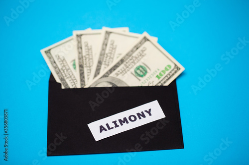 The concept of paying alimony, money in a paper envelope