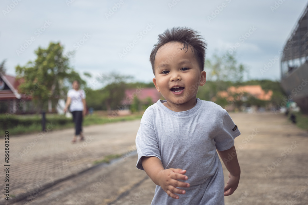 portrait of a active cute little asian boy Playing and running in a park in summer season portrait of a active cute little asian boy Playing and running in a park in summer season