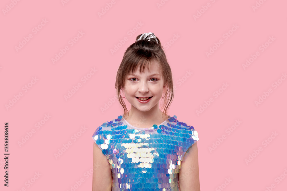 Smiling sweet girl looks into the camera. Holiday dress Smiling sweet girl looks into the camera. Holiday dress