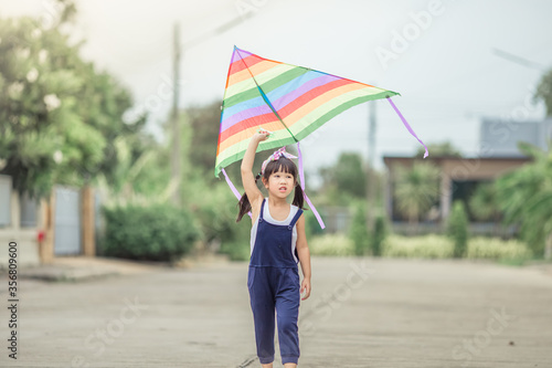 Close-up view of cute girl playing with sports (kite sport), learning outside the classroom during the summer semester and making good use of leisure time.